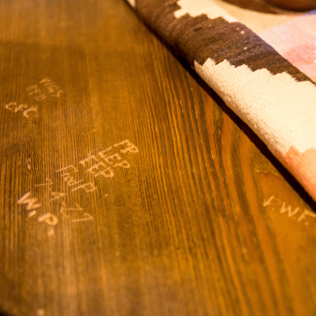 During a housewarming on July 4, 1927, Waite and his brothers carved their initials into a table. The reasons for the carvings are unknown, but it's suspected to have occured during an all night poker game.