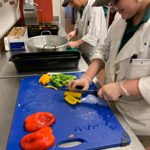 Vo]ictoria Hill prepares fresh peppers for the CHQ Staff DIning Hall