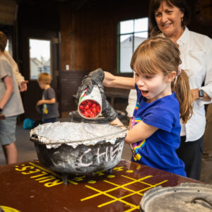 An Autumn Family Adventure participant pours cherries into a dutch oven at the Philmont Training Center in Cimarron N.M. on September 14th, 2024.