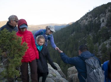 Families staying at the Philmont Training Center help each other document the hike out to Lover's Leap by taking each other's family photos on June 13, 2023 in Cimarron, N.M.