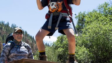 On June 27th, PTC family participants took a hike to the TRex Track. Two participants excitedly begin their hike, crossing the fence into the backcountry.